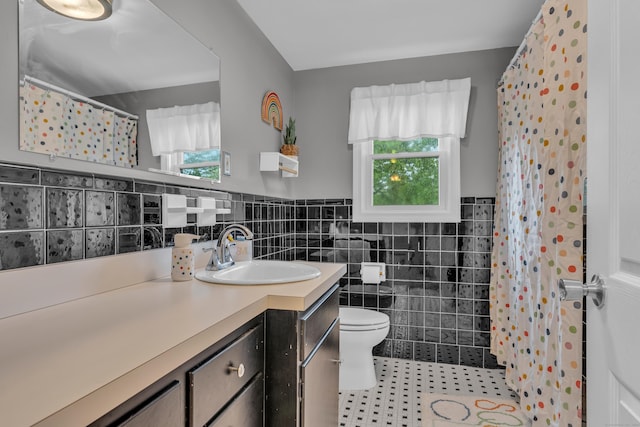 255 Back Ln, Newington, CT 06111 - bathroom featuring tile walls, plenty of natural light, vanity, toilet, and tile patterned floors