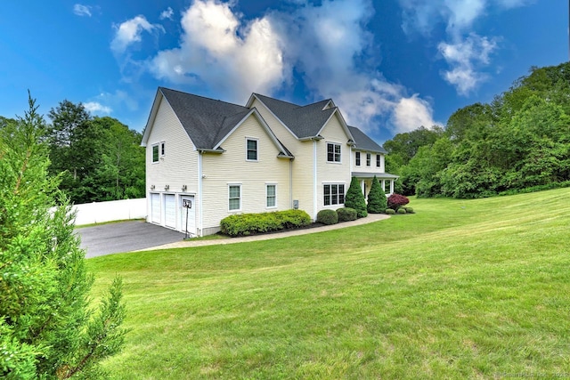 2 Butternut Ridge Rd, Oxford, CT 06478 - view of side of home featuring an attached garage, driveway, and a lawn
