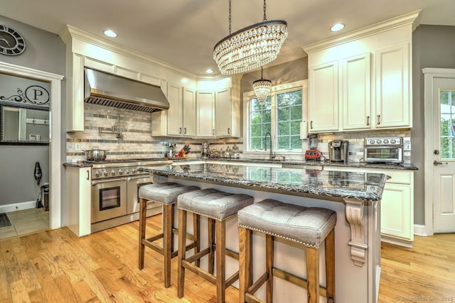 2 Butternut Ridge Rd, Oxford, CT 06478 - kitchen with wall chimney exhaust hood, double oven range, healthy amount of natural light, decorative backsplash, and recessed lighting
