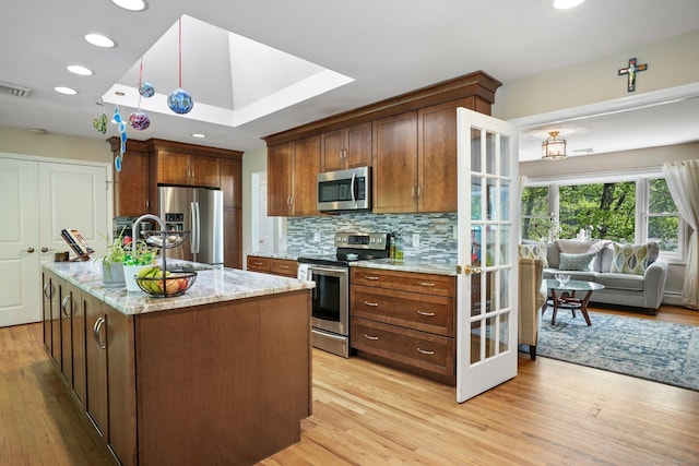 25 Fleetwood Dr, New Fairfield, CT 06812 - kitchen featuring appliances with stainless steel finishes, light wood-style flooring, light stone counters, tasteful backsplash, and recessed lighting