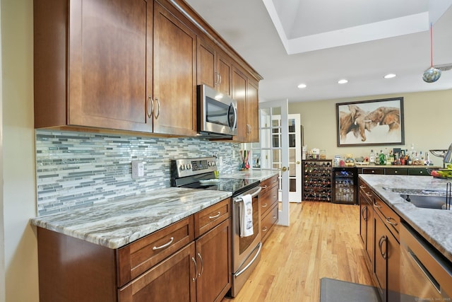 25 Fleetwood Dr, New Fairfield, CT 06812 - kitchen with appliances with stainless steel finishes, light stone countertops, light wood finished floors, decorative backsplash, and recessed lighting