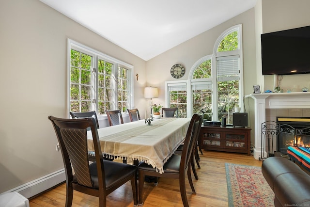 25 Fleetwood Dr, New Fairfield, CT 06812 - dining area featuring vaulted ceiling, healthy amount of natural light, wood finished floors, and a tiled fireplace