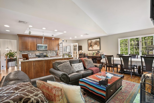 25 Fleetwood Dr, New Fairfield, CT 06812 - living area featuring a raised ceiling, light wood-type flooring, and recessed lighting