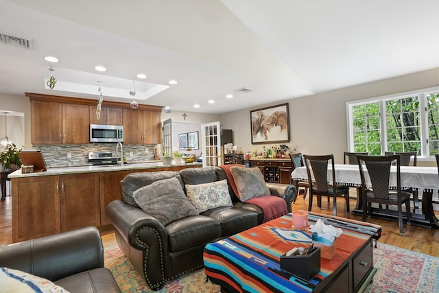 25 Fleetwood Dr, New Fairfield, CT 06812 - living area featuring light wood-style floors, recessed lighting, and a tray ceiling