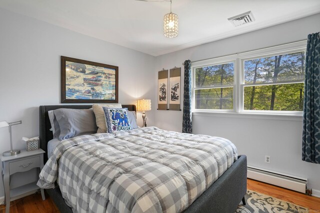 25 Fleetwood Dr, New Fairfield, CT 06812 - bedroom featuring a baseboard heating unit and wood finished floors