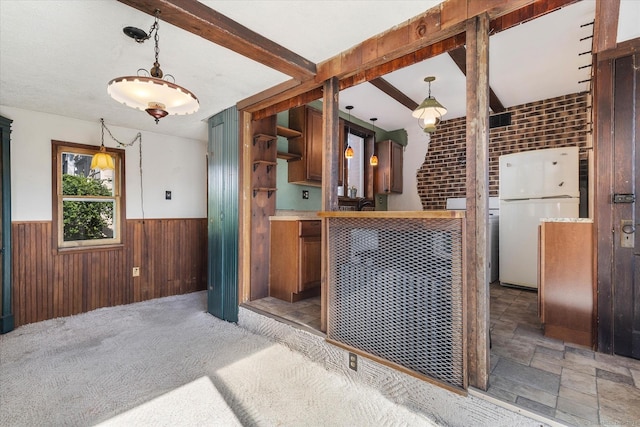 16 Hill Rd, East Lyme, CT 06333 - kitchen with freestanding refrigerator, wainscoting, wood walls, and pendant lighting