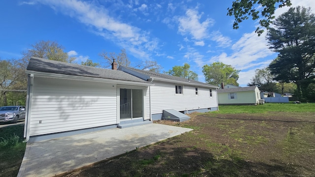 137 Wells Rd, East Windsor, CT 06088 - rear view of house with a chimney, a patio area, roof with shingles, and a yard