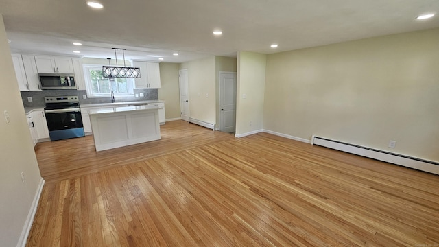 137 Wells Rd, East Windsor, CT 06088 - kitchen featuring appliances with stainless steel finishes, a baseboard radiator, light countertops, light wood-style floors, and baseboards