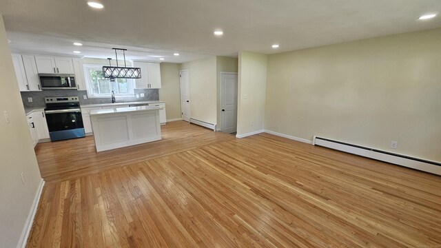 137 Wells Rd, East Windsor, CT 06088 - kitchen featuring appliances with stainless steel finishes, a baseboard radiator, light countertops, light wood-style floors, and baseboards