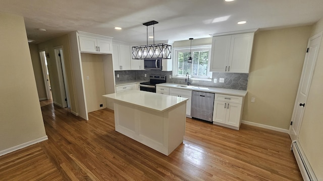 137 Wells Rd, East Windsor, CT 06088 - kitchen with stainless steel appliances, baseboard heating, white cabinetry, decorative backsplash, and recessed lighting