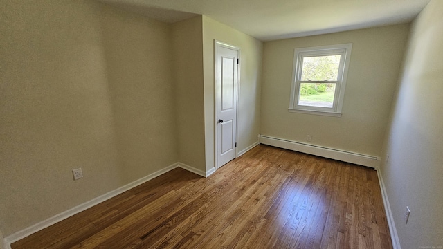 137 Wells Rd, East Windsor, CT 06088 - unfurnished bedroom featuring a baseboard heating unit, baseboards, and wood finished floors