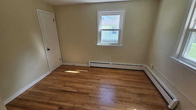 137 Wells Rd, East Windsor, CT 06088 - unfurnished room featuring baseboard heating, wood finished floors, and baseboards