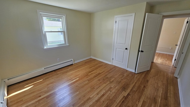 137 Wells Rd, East Windsor, CT 06088 - unfurnished bedroom with a baseboard radiator, wood finished floors, and baseboards