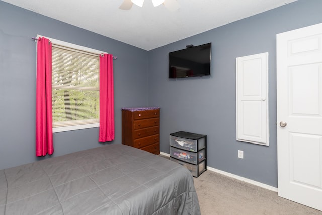 carpeted bedroom featuring a ceiling fan and baseboards