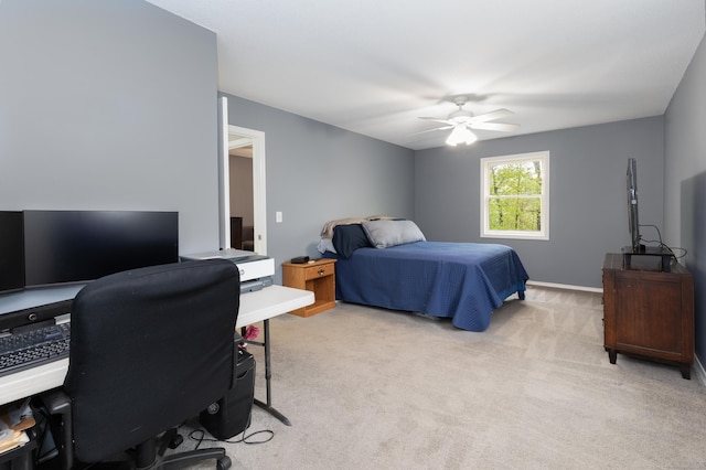 bedroom with light colored carpet, a desk, and ceiling fan