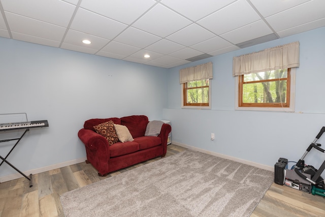 sitting room with a paneled ceiling, baseboards, wood finished floors, and recessed lighting