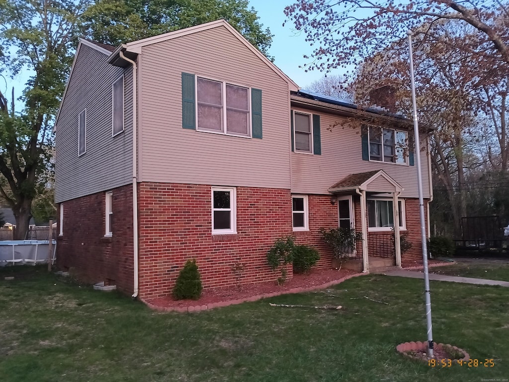 20 Coolidge St, Southington, CT 06489 - view of front facade featuring brick siding and a front lawn
