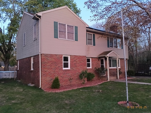 20 Coolidge St, Southington, CT 06489 - view of front facade featuring brick siding and a front lawn