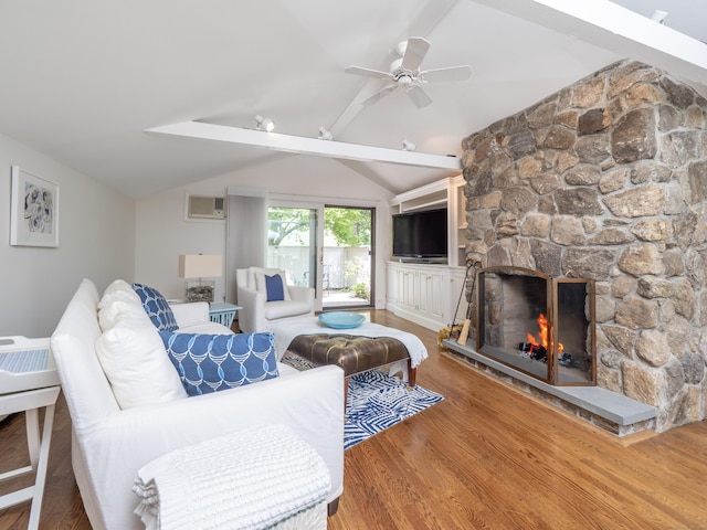 18 Calvin Rd, Weston, CT 06883 - living room with a stone fireplace, wood finished floors, ceiling fan, and a wall mounted air conditioner