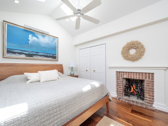 18 Calvin Rd, Weston, CT 06883 - bedroom with wood finished floors, vaulted ceiling, a brick fireplace, recessed lighting, and a closet