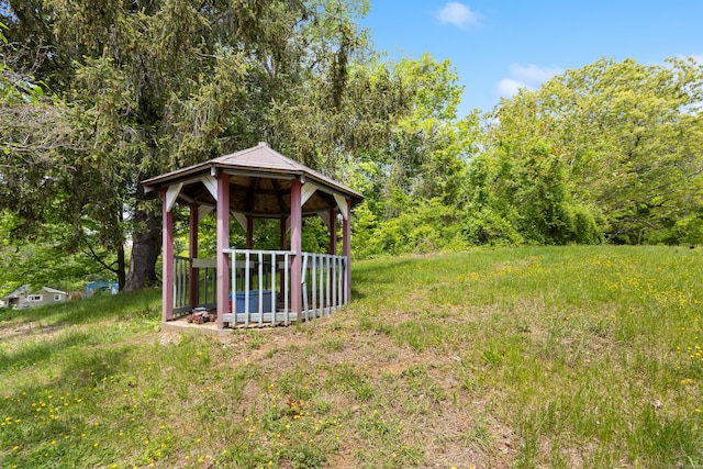view of yard featuring a gazebo and a forest view