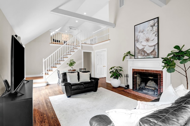 living area with stairs, wood finished floors, recessed lighting, baseboards, and a fireplace