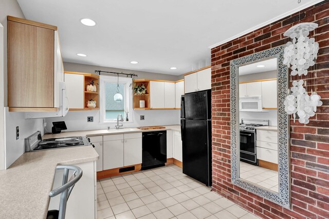kitchen featuring black appliances, open shelves, light countertops, a sink, and light tile patterned floors