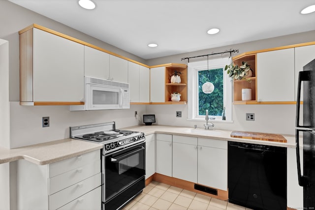 kitchen featuring black appliances, open shelves, a sink, light countertops, and light tile patterned floors