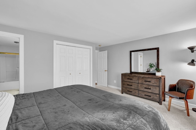 bedroom with carpet, a closet, and baseboards