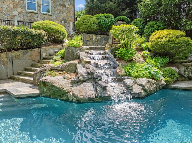 view of pool featuring stairway