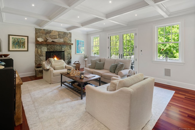 living area with wood finished floors, baseboards, coffered ceiling, beam ceiling, and a fireplace
