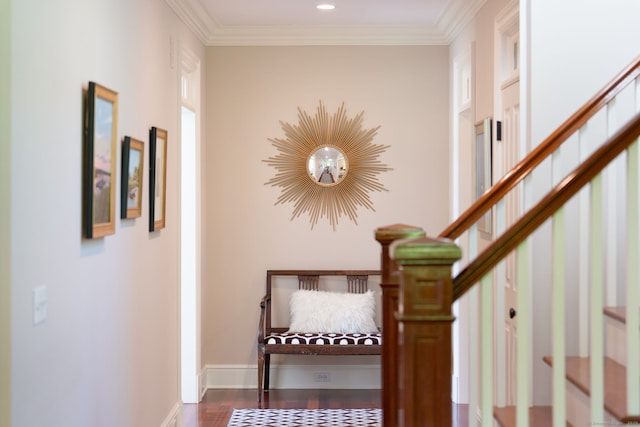 stairway with wood finished floors, crown molding, and baseboards