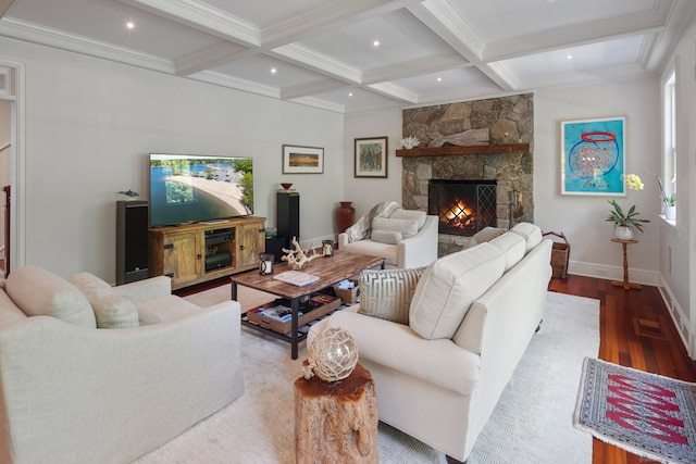 living area with wood finished floors, beamed ceiling, baseboards, a fireplace, and coffered ceiling