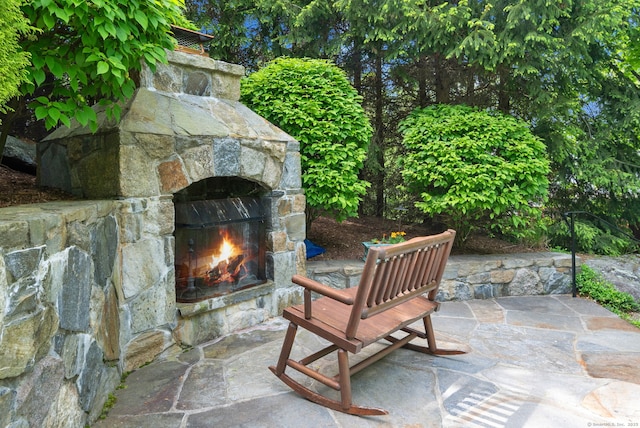 view of patio / terrace featuring an outdoor stone fireplace