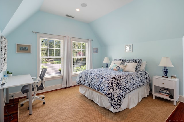 bedroom featuring lofted ceiling, baseboards, an office area, and light wood-style floors