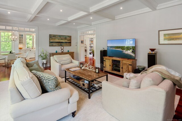 living room featuring coffered ceiling, beamed ceiling, a chandelier, ornamental molding, and recessed lighting