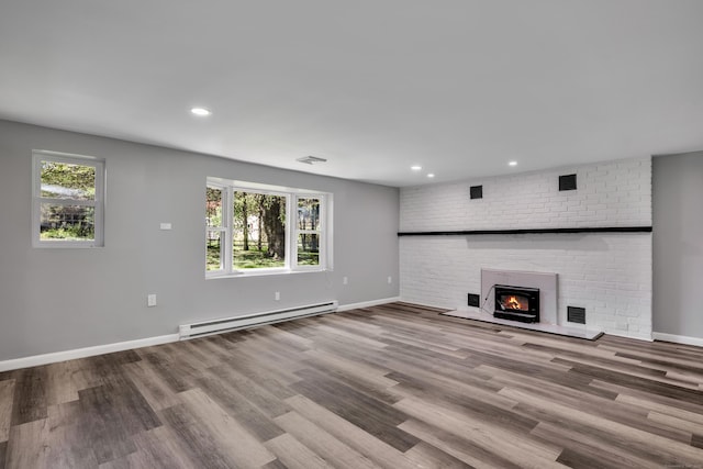 779 New Britain Ave, Rocky Hill, CT 06067 - unfurnished living room with a baseboard heating unit, baseboards, recessed lighting, a fireplace, and wood finished floors
