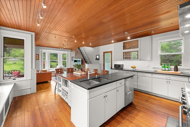 13 Sugar St, Newtown, CT 06470 - kitchen featuring rail lighting, a sink, wood ceiling, a kitchen island with sink, and dark countertops