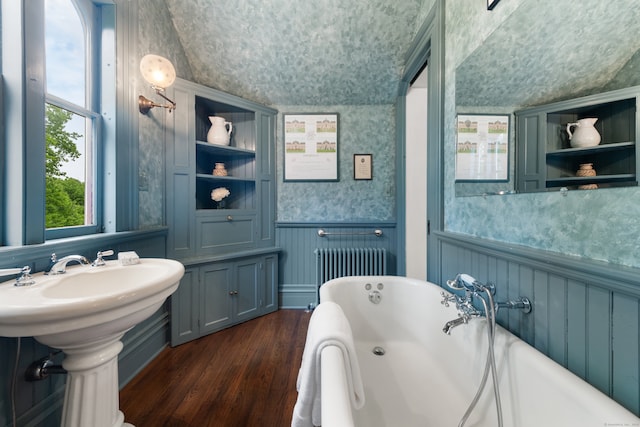 13 Sugar St, Newtown, CT 06470 - bathroom featuring wallpapered walls, radiator, wood finished floors, a freestanding tub, and wainscoting