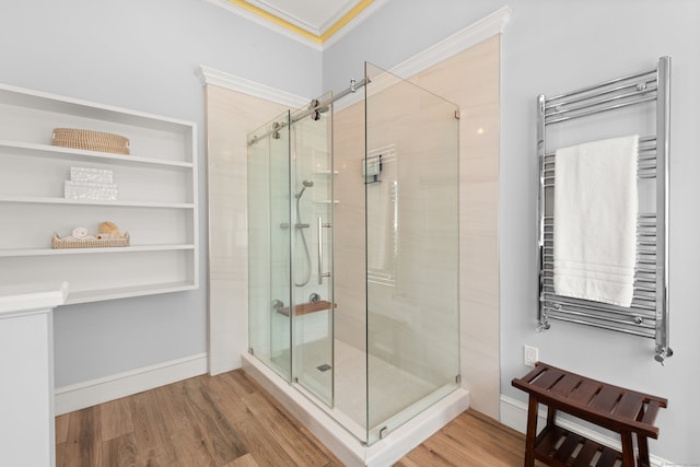 13 Sugar St, Newtown, CT 06470 - full bath with radiator heating unit, a towel warmer, a shower stall, ornamental molding, and wood finished floors