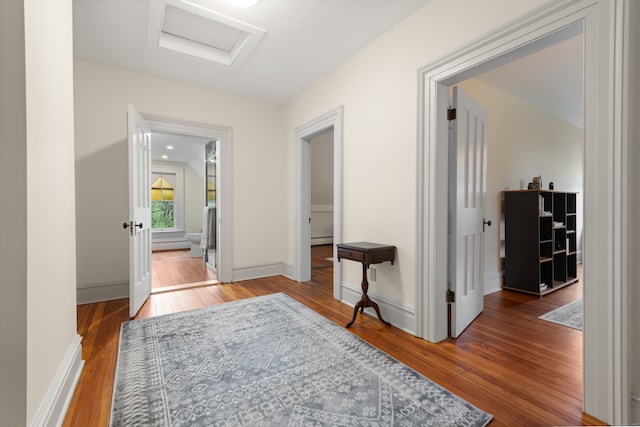13 Sugar St, Newtown, CT 06470 - hallway with attic access, wood-type flooring, a baseboard heating unit, and baseboards