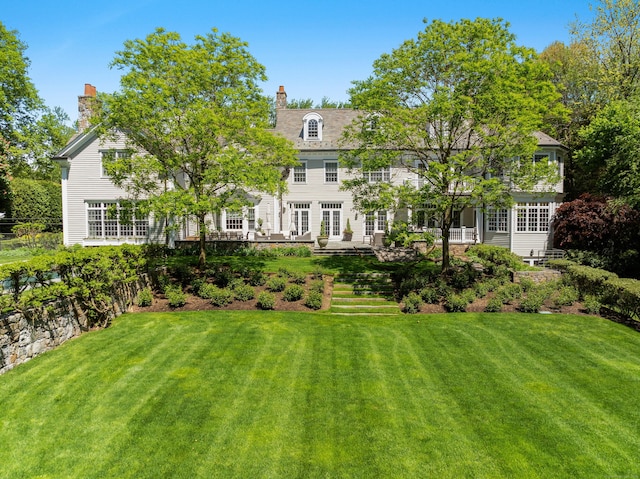 68 Woods End Rd, New Canaan, CT 06840 - back of property featuring a lawn and a chimney