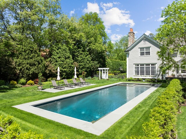 68 Woods End Rd, New Canaan, CT 06840 - outdoor pool featuring a yard, a patio, and view of scattered trees