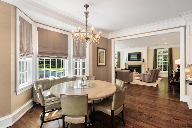 68 Woods End Rd, New Canaan, CT 06840 - dining space with a lit fireplace, dark wood-type flooring, a chandelier, ornamental molding, and baseboards