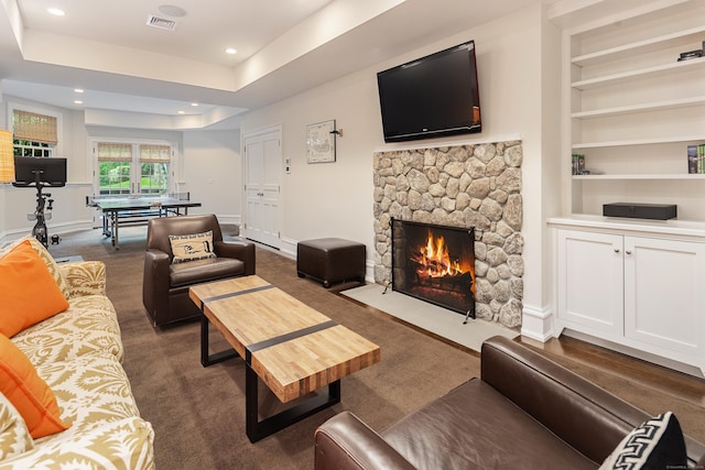 68 Woods End Rd, New Canaan, CT 06840 - living area with dark carpet, baseboards, a stone fireplace, recessed lighting, and built in shelves