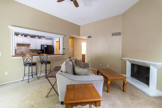 11 Byrne Ct Unit C2, Farmington, CT 06032 - living area featuring light carpet, a ceiling fan, a fireplace with raised hearth, and baseboards