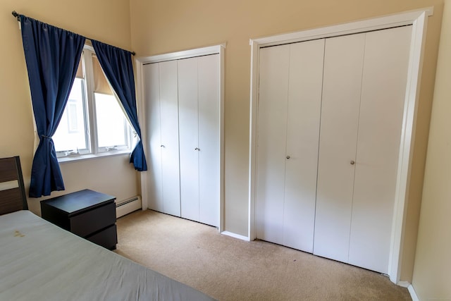 11 Byrne Ct Unit C2, Farmington, CT 06032 - carpeted bedroom with two closets, a baseboard heating unit, and baseboards