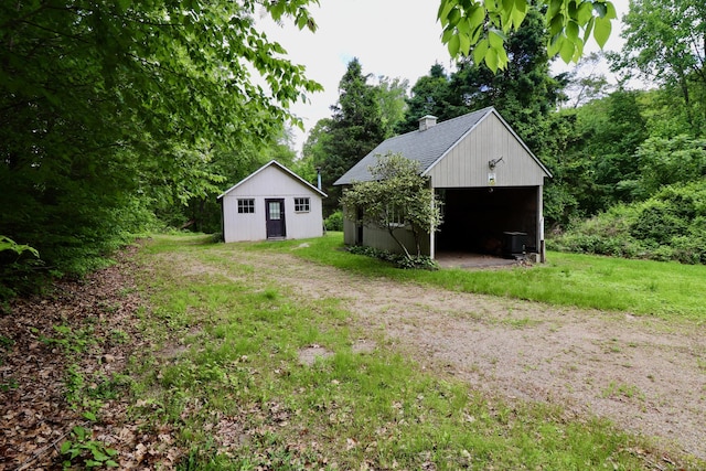 152 Cedar Ln, Middletown, CT 06457 - view of green lawn with a detached garage and an outbuilding