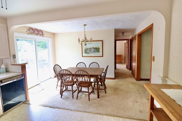 152 Cedar Ln, Middletown, CT 06457 - dining room featuring arched walkways, a chandelier, and light carpet