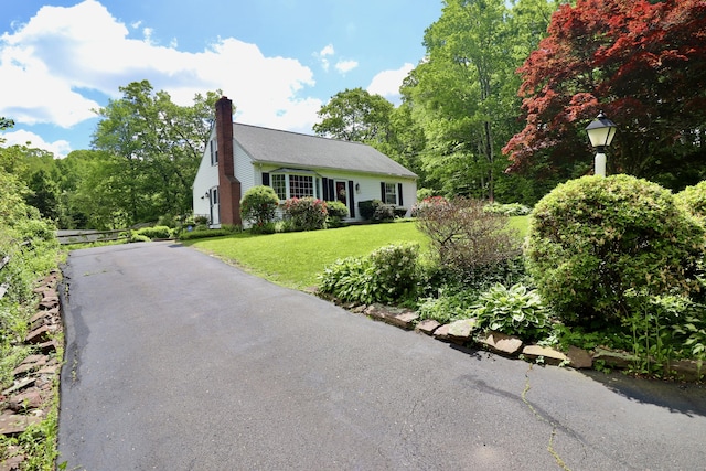152 Cedar Ln, Middletown, CT 06457 - view of front of house featuring a chimney, a front lawn, and driveway
